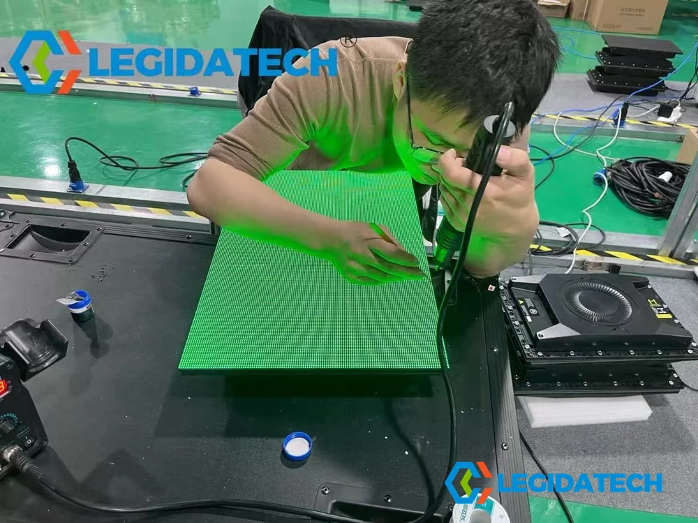 QC technician inspecting and calibrating Ehonor 480x320mm indoor LED screen panel at quality control station