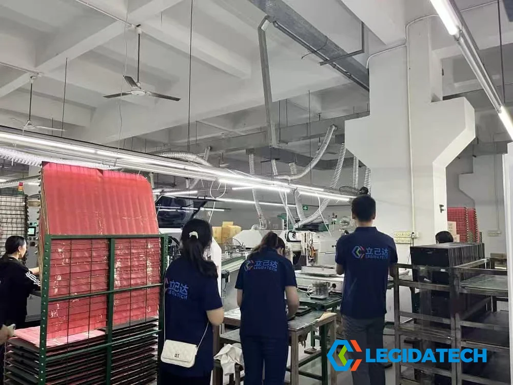 Workers operating SMT machinery on the Ehonor LED module production workshop floor at LEGIDATECH factory