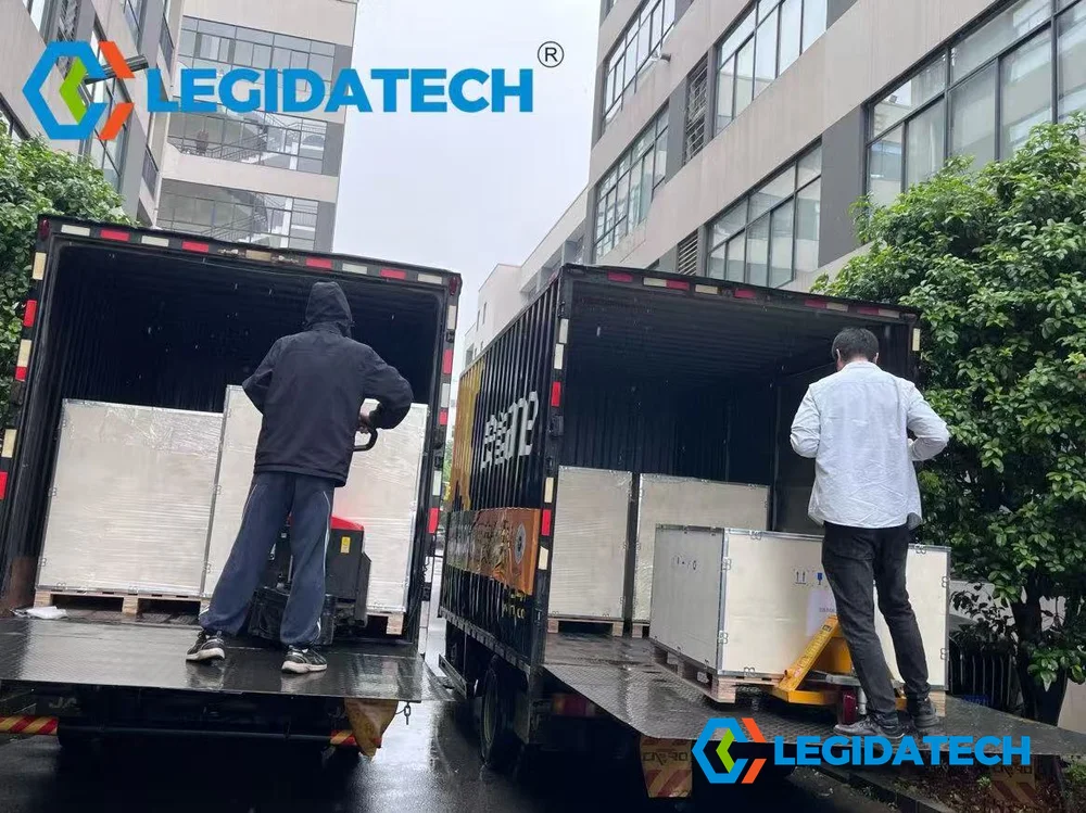 LEGIDATECH staff loading boxed Ehonor LED screen cabinets into shipping vehicle for container transport and global export