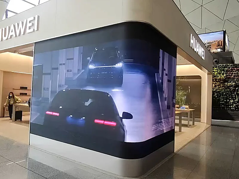 Curved indoor LED display wall wrapping a room corner