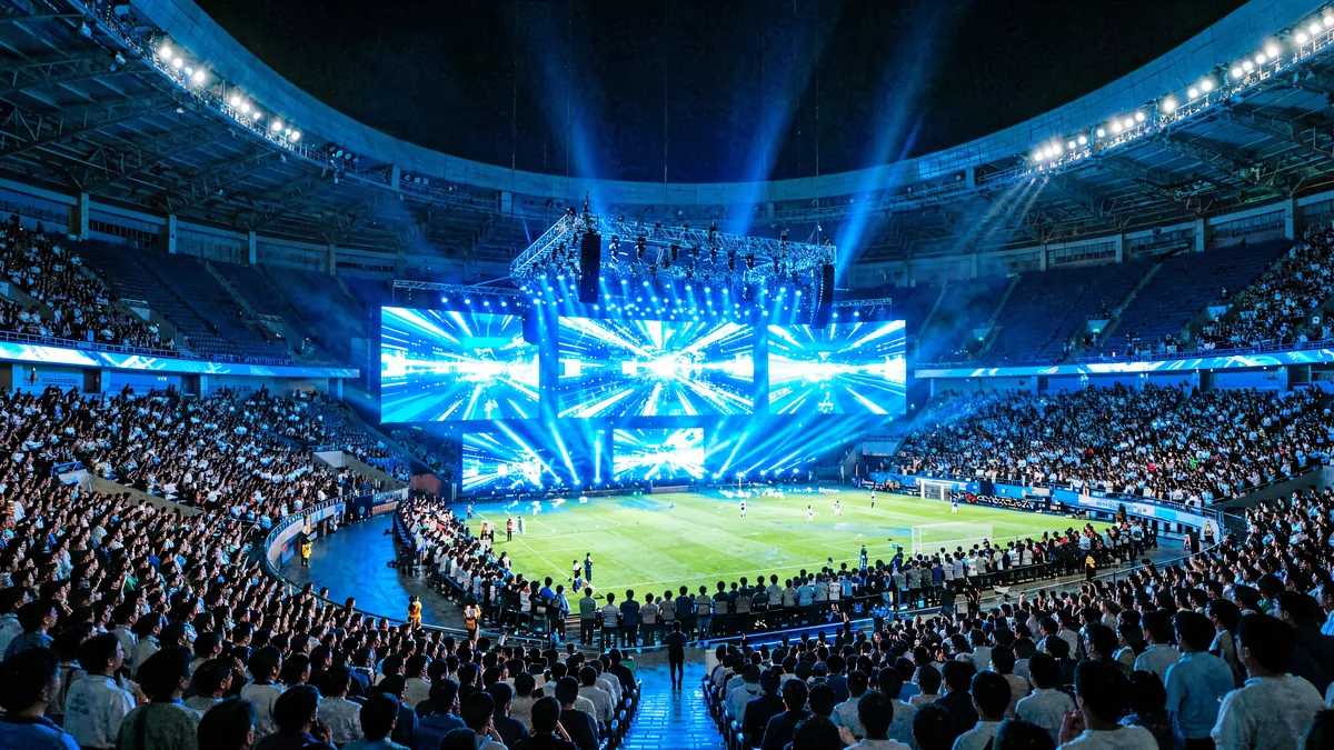 LED display screens inside a sports arena during an event