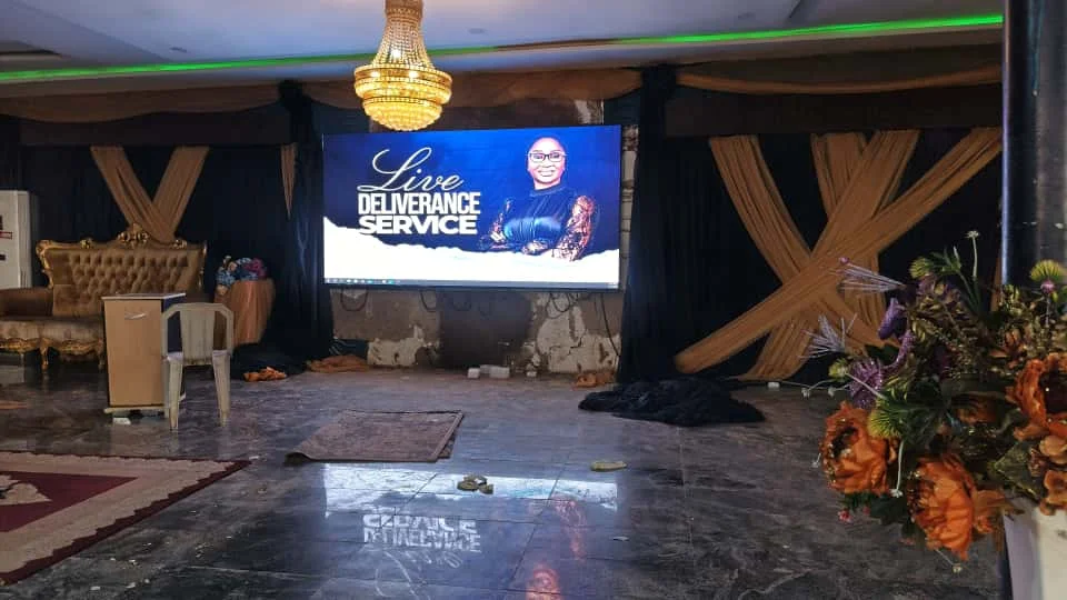 Church LED screen in Abuja Nigeria showing a live deliverance service in a decorated worship hall