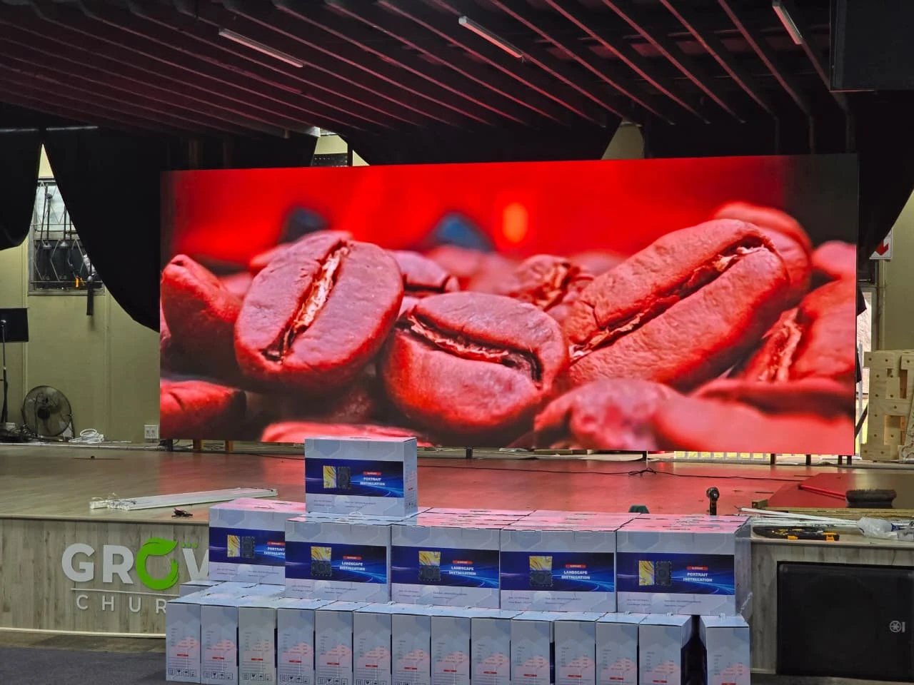 Ehonor Series P2.5 church LED screen during commissioning at GROW Church South Africa, packaging boxes still on the stage floor