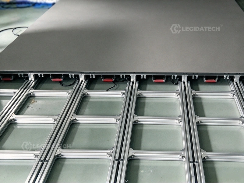Guide rails aligning the first row of an interactive LED floor installation