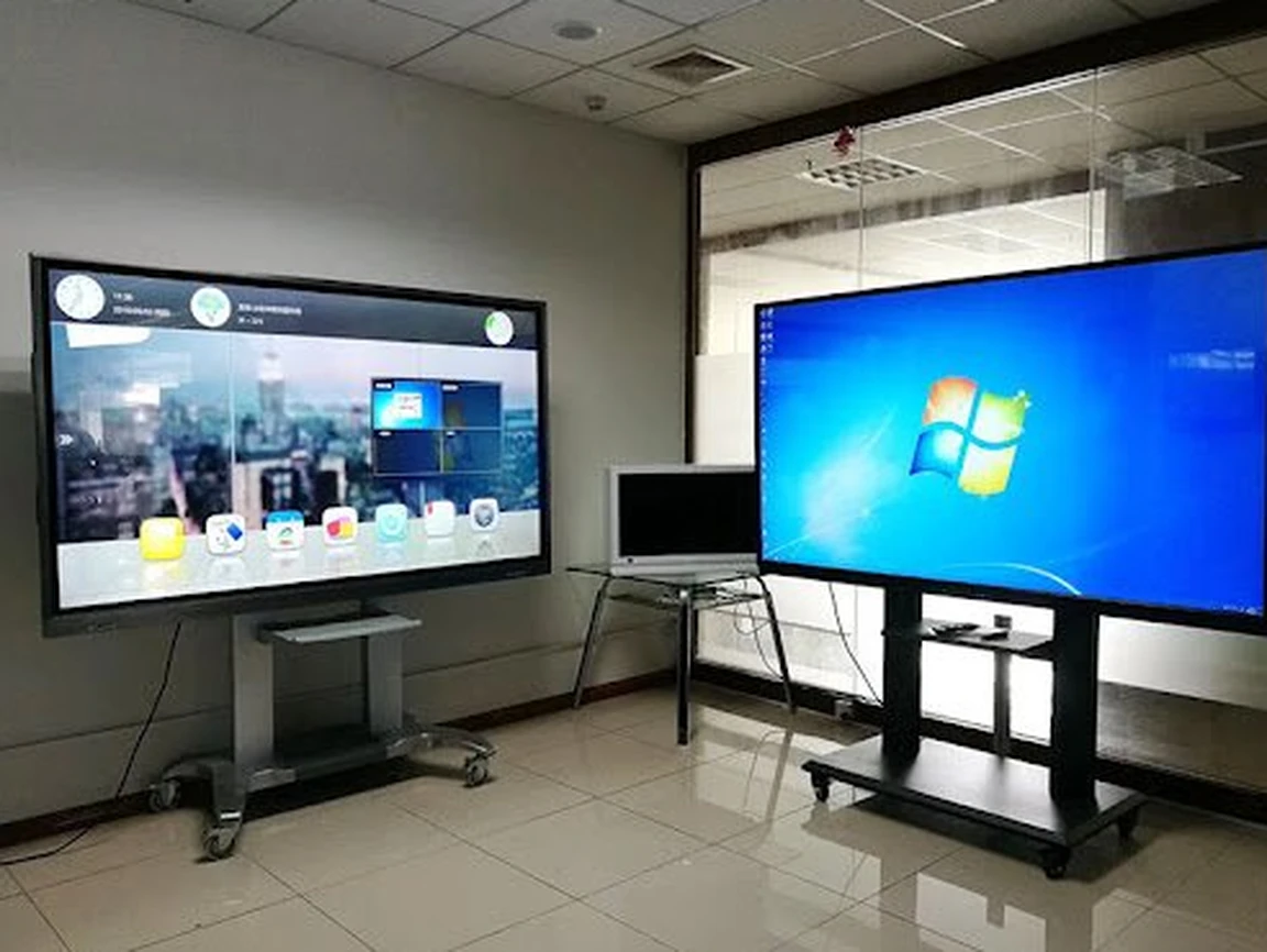 Two all-in-one LED displays on mobile carts in a working meeting room