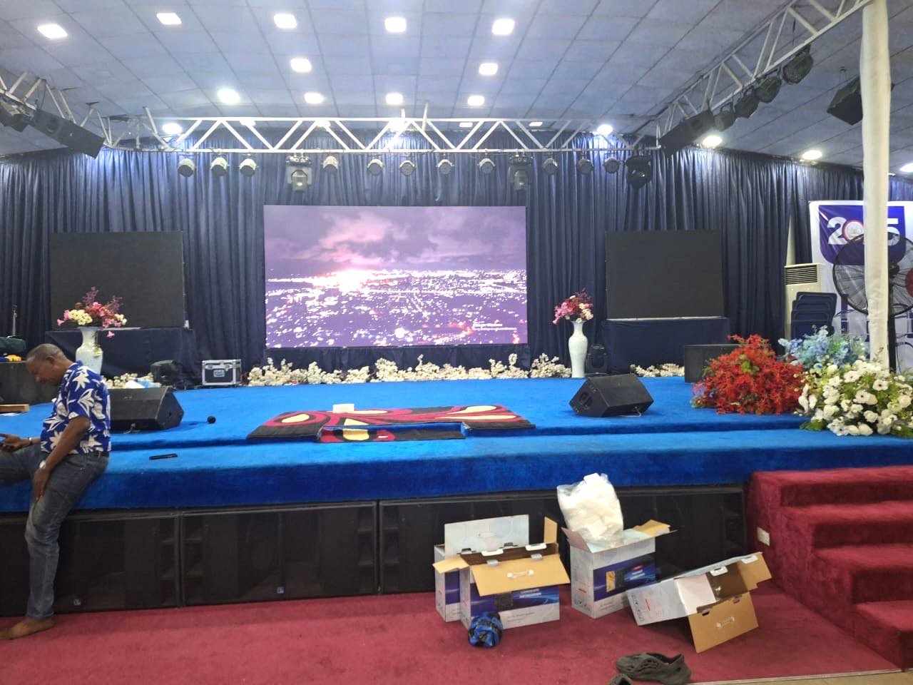 Photo from the project site: the 4.48 x 2.4 m Ehonor P2.5 church LED screen playing video content above the tiered stage at Salem Christian Ministry in Lekki, Lagos